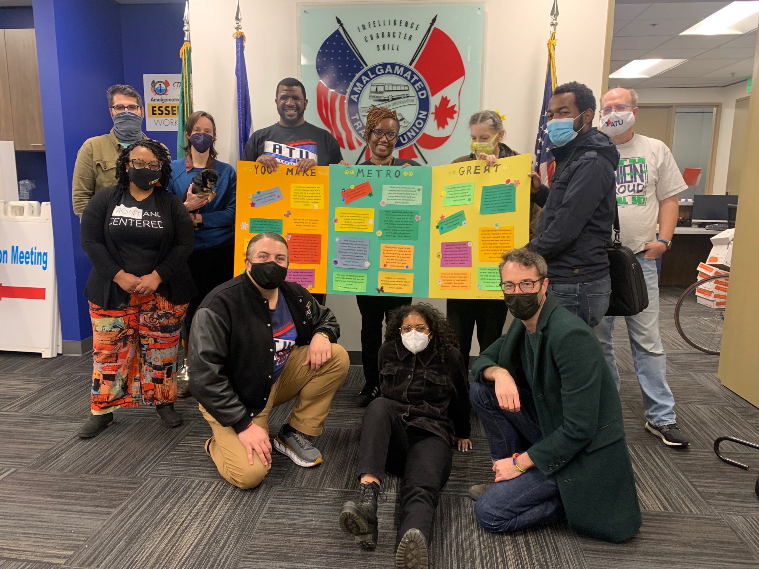 Image of 11 people in front of a big thank you card to transit operators